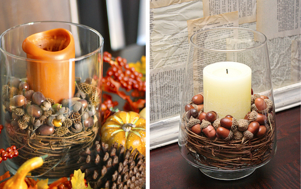 Glass hurricane candle filled with faux acorns and twigs for an easy DIY Thanksgiving centerpiece.