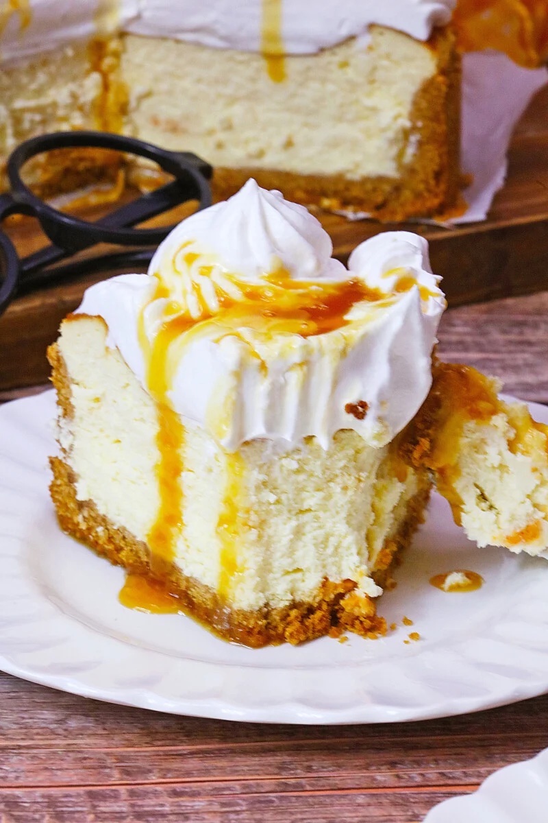 Harry Potter butterbeer cheesecake featuring a graham cracker crust with a smooth butterscotch filling topped with fluffy Cool Whip and a drizzle of butterscotch sauce.