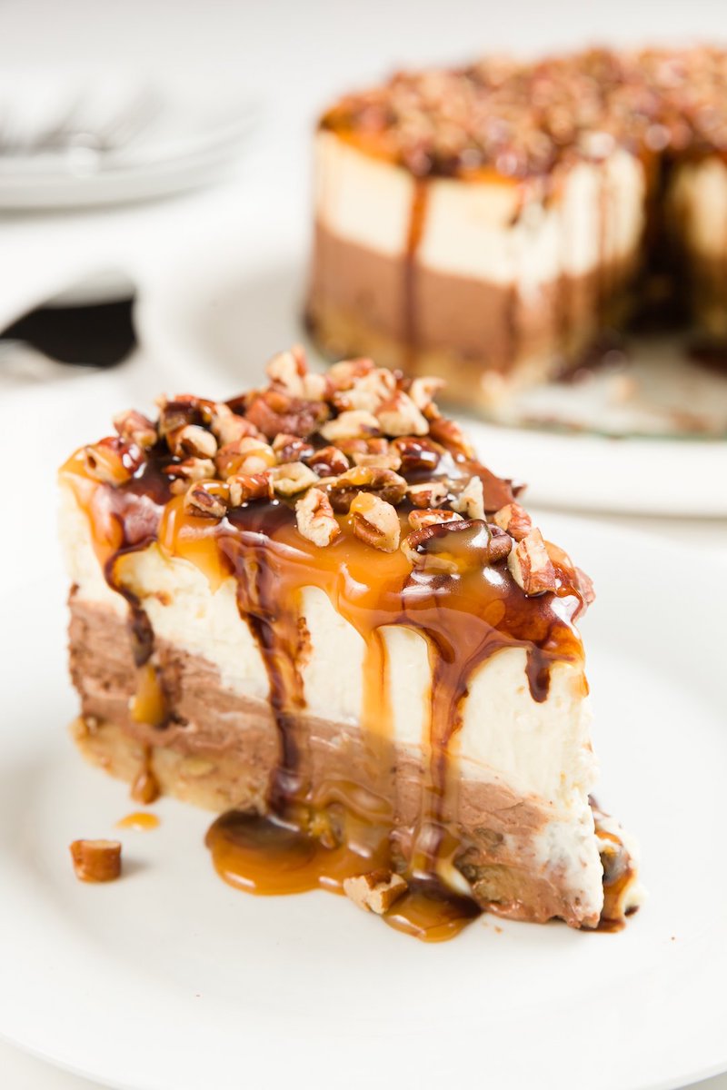 Turtle cheesecake, a New York style cheesecake layered with caramel, pecans, and chocolate.