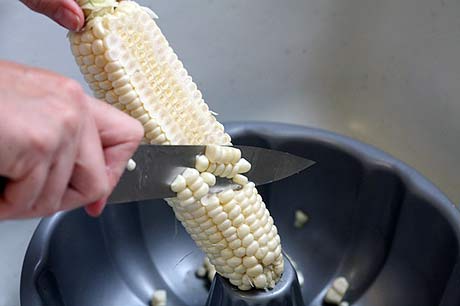 Cut corn on the cob with a Bundt pan. Genius Kitchen Hacks