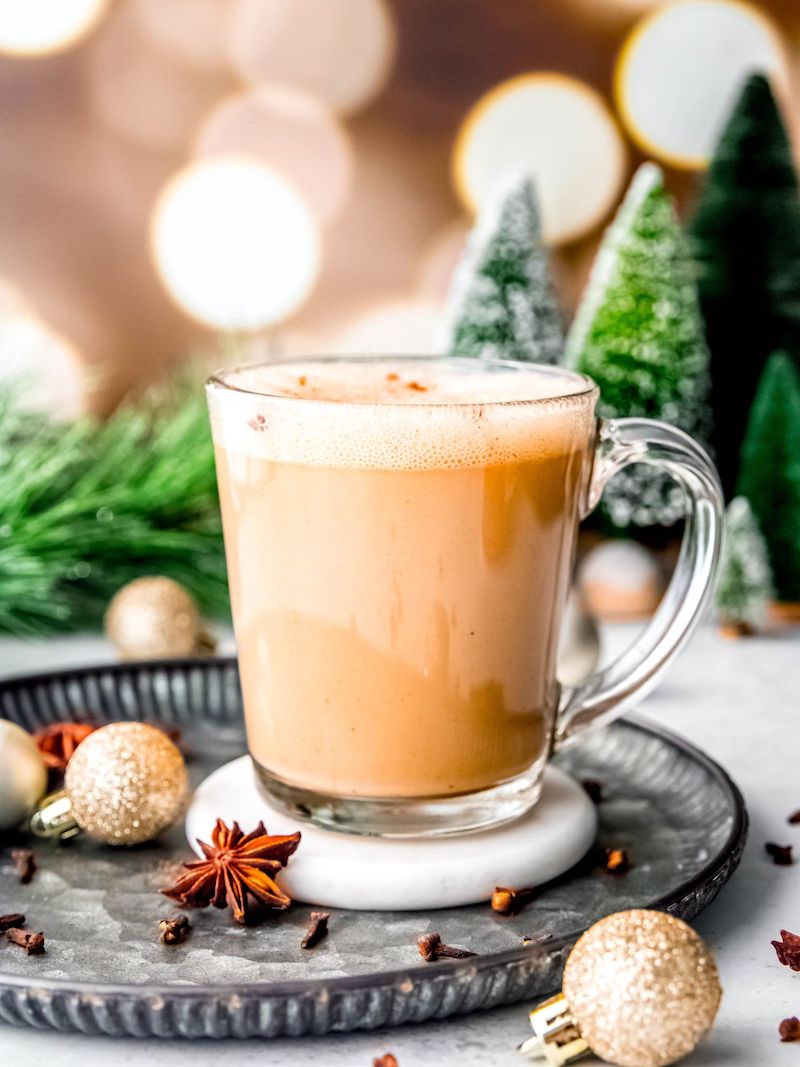 Starbucks Eggnog Latte topped with frothy milk and a sprinkle of ground nutmeg in a white mug.