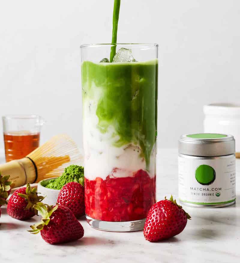 A Starbucks copycat Iced Strawberry Matcha Latte layered with fresh strawberries, creamy milk, and vibrant green matcha over ice.