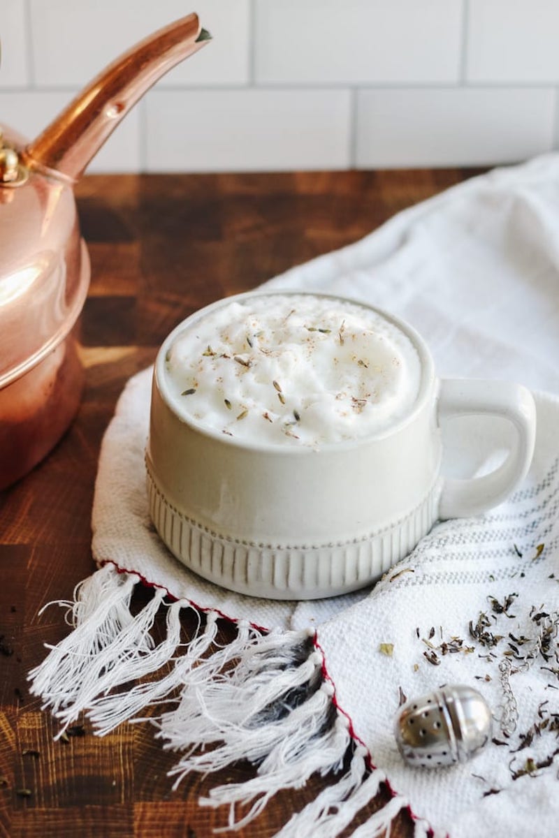 A homemade London Fog Latte topped with creamy milk foam and dried lavender.