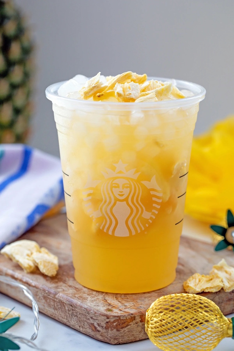 A refreshing Starbucks copycat Pineapple Passionfruit Refresher served over ice with freeze-dried pineapple.