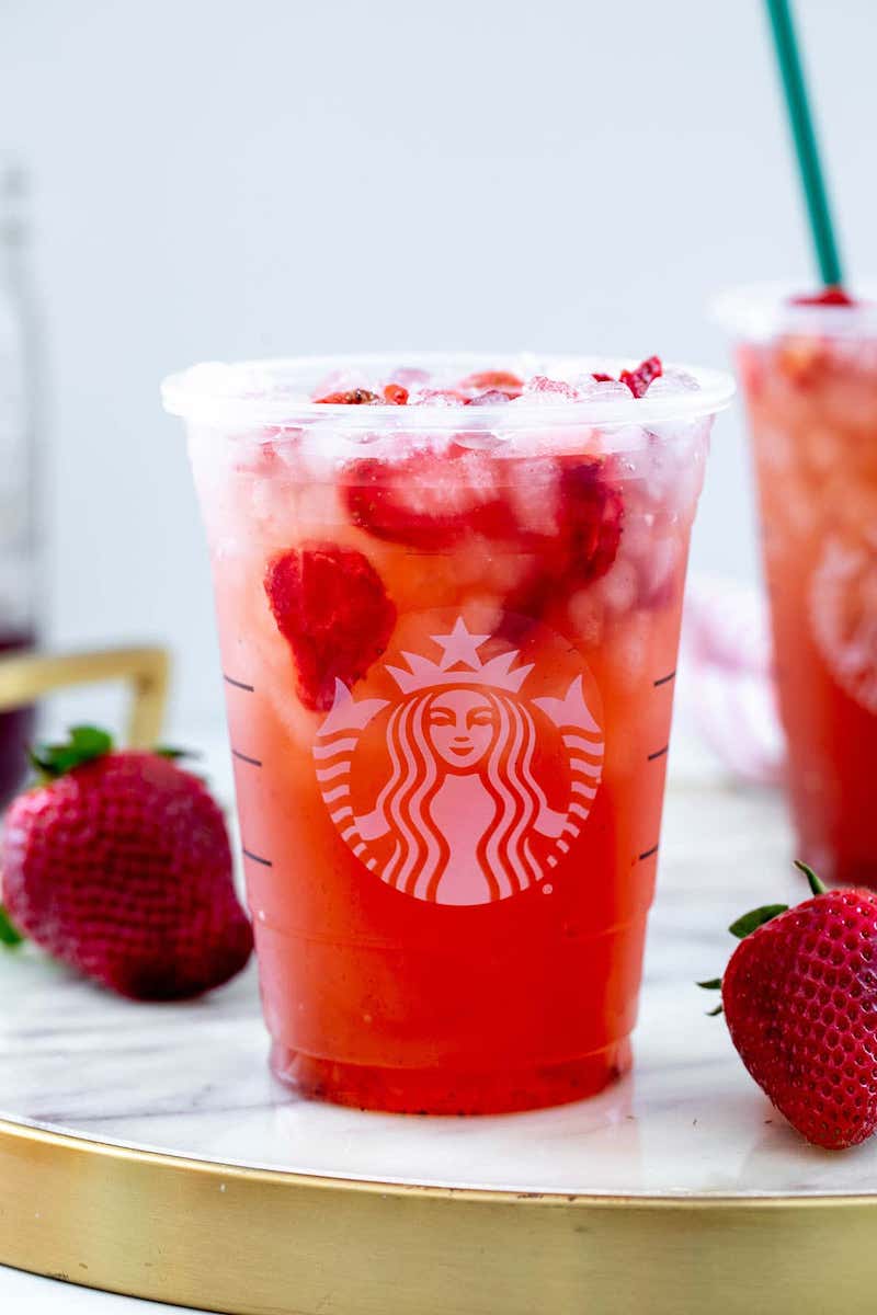 A Starbucks copycat Strawberry Açaí Refresher served over ice with freeze-dried strawberries.