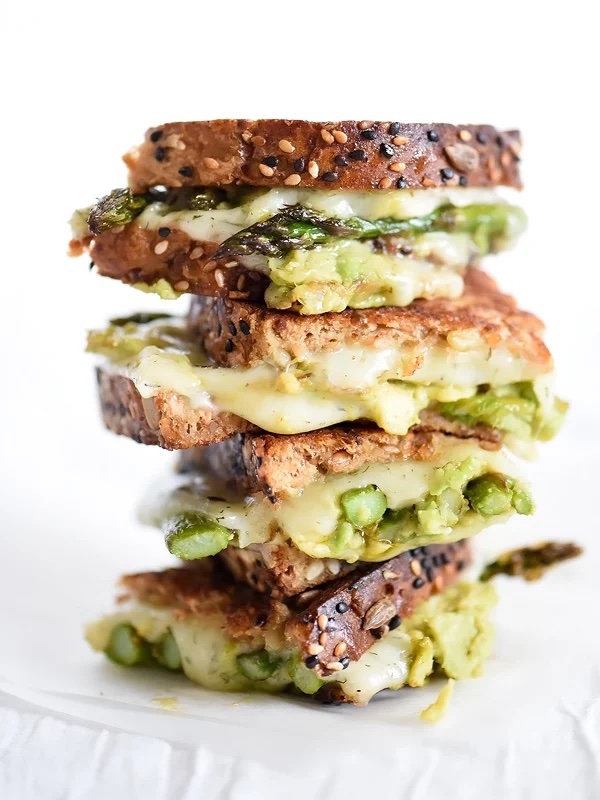 Stacked grilled cheese sandwiches made with roasted asparagus, smashed avocado, dill Havarti cheese, and toasted multigrain bread.