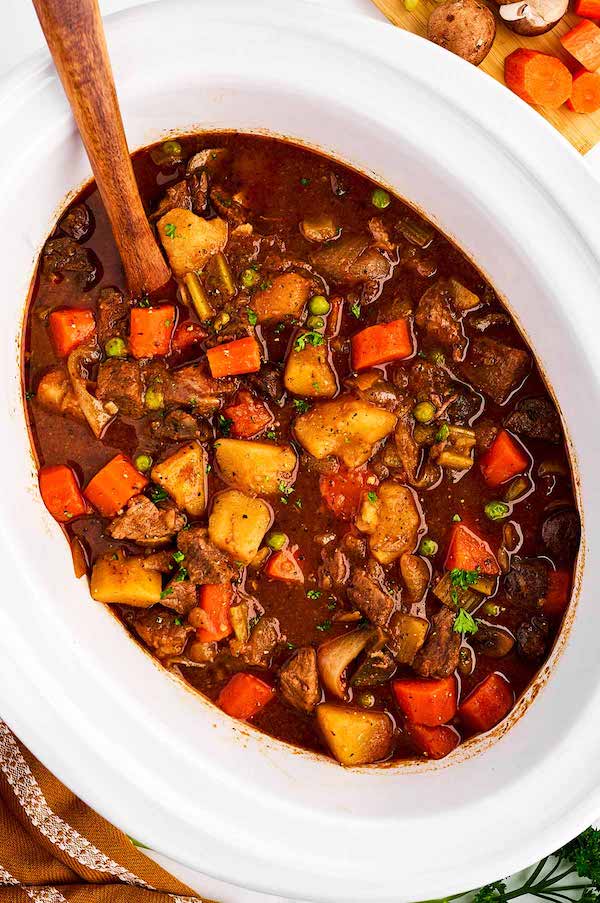 Overhead of Crockpot beef stew made with chunks of beef, potatoes, and carrots.