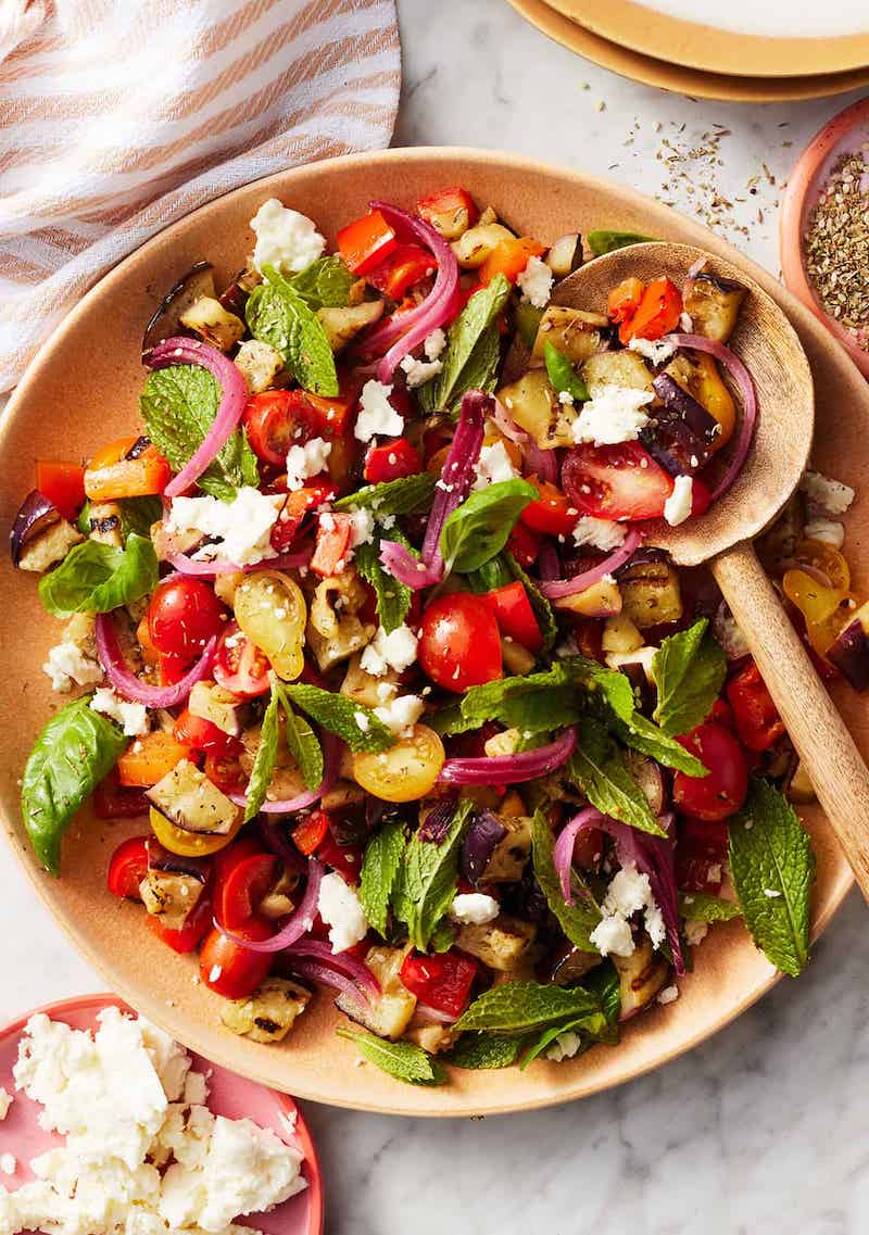 Eggplant Salad
rate this recipe:5 from 17 votes
Prep Time: 20minutes minsCook Time: 10minutes minsTotal Time: 30minutes mins
Serves 4
Save Recipe Print Recipe
This eggplant salad recipe is a fresh, vibrant summer side dish! Serve it as a side salad with a simply cooked protein, or try one of the serving suggestions in the blog post above.
Ingredients
2 tablespoons extra-virgin olive oil, plus more for drizzling
1 tablespoon fresh lemon juice
2 garlic cloves, grated
½ teaspoon za’atar
½ teaspoon sea salt, plus more for sprinkling
Freshly ground black pepper
1 medium eggplant, 1 pound, cut into ½-inch-thick rounds
1 red bell pepper, stemmed, seeded, and quartered lengthwise
1 cup cherry tomatoes, halved
½ cup crumbled feta cheese
⅓ cup Pickled Red Onions
⅓ cup fresh basil leaves
⅓ cup fresh mint leaves
Cook Mode
Prevent your screen from going dark
Instructions
In a large bowl, whisk together the olive oil, lemon juice, garlic, za’atar, salt, and pepper.
Heat a grill or grill pan to medium-high heat.
Place the eggplant and red pepper pieces on a large plate or in a large baking dish and drizzle with olive oil and sprinkle with salt and pepper. Toss to coat.
Place the eggplant and pepper on the hot grill and cook for 2 to 5 minutes per side, or until well charred and tender. Remove from the grill and chop into 1-inch pieces.
Add the grilled veggies to the bowl with the dressing and stir to coat. Let sit for 5 minutes, then fold in the tomatoes, feta, pickled red onions, and half the basil and mint. Season to taste, garnish with the remaining basil and mint, and serve.