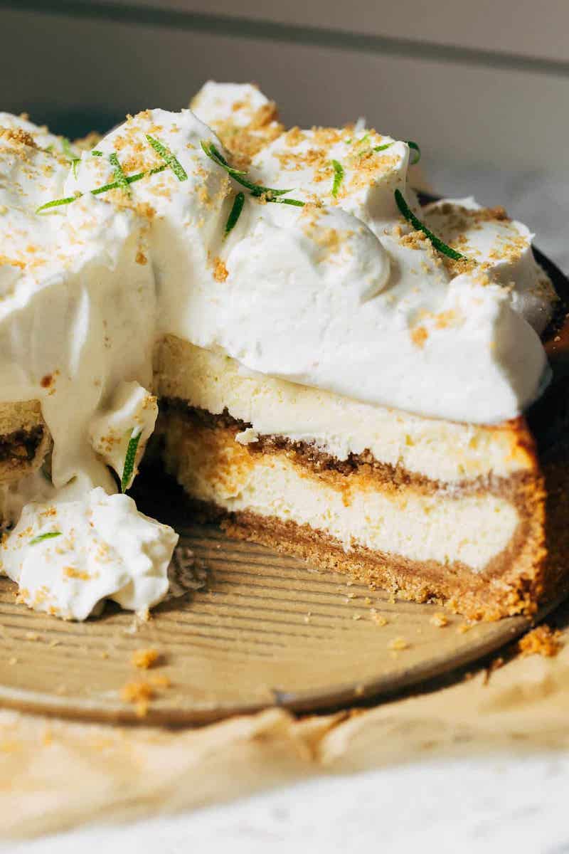 Key lime pie cheesecake topped with whipped cream.