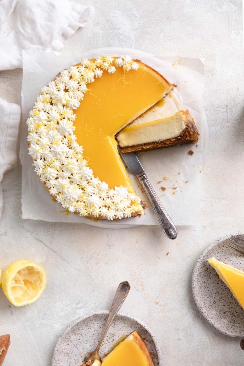 Lemon curd cheesecake with whipped cream.