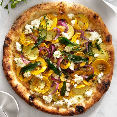 Yellow squash and goat cheese pizza topped with fresh thyme, sage, and red onion.