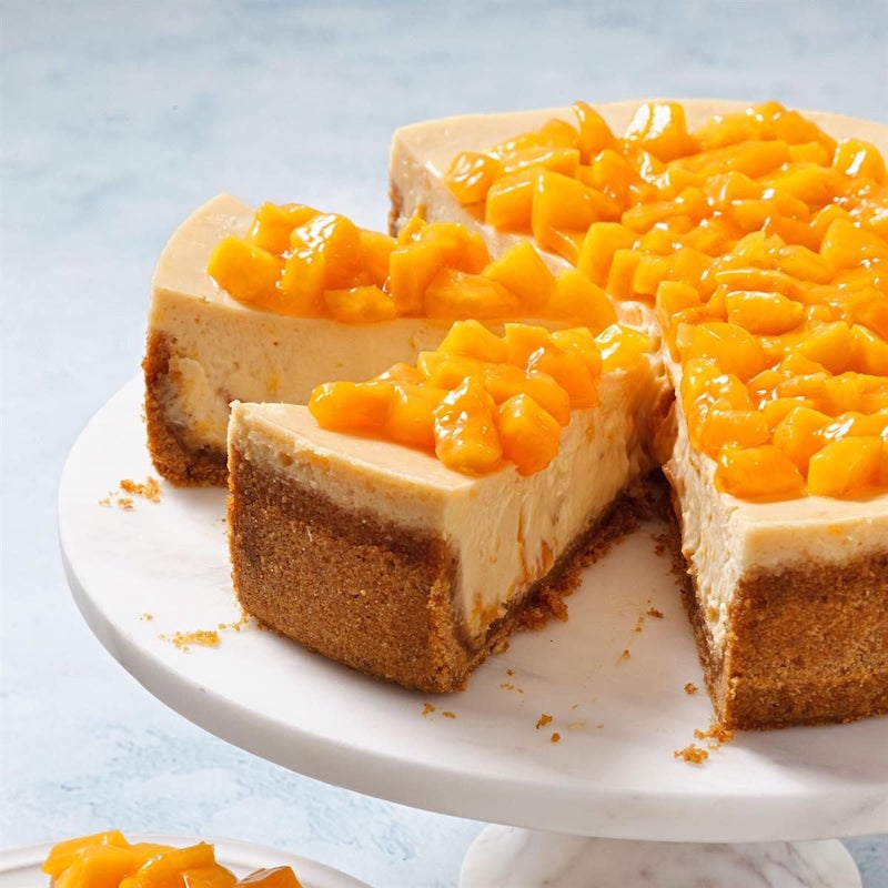 Fresh peach cheesecake topped with glossy peach compote.